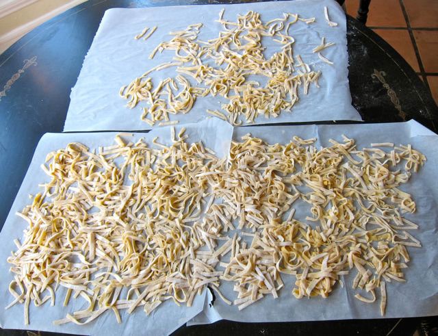 Cut noodles drying on parchment.