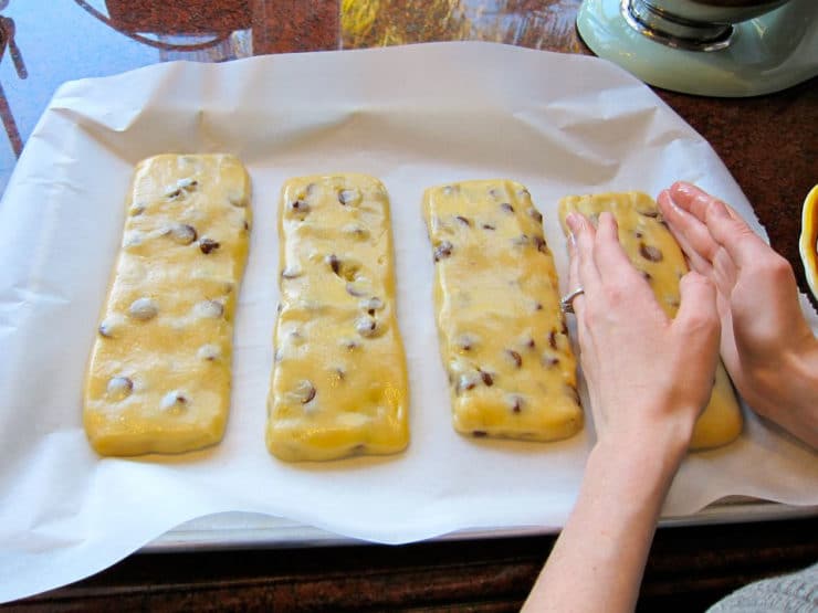 Mandel bread in 4 rectangles on a lined baking sheet.