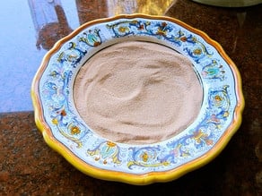 Combining cinnamon and sugar in a shallow bowl.