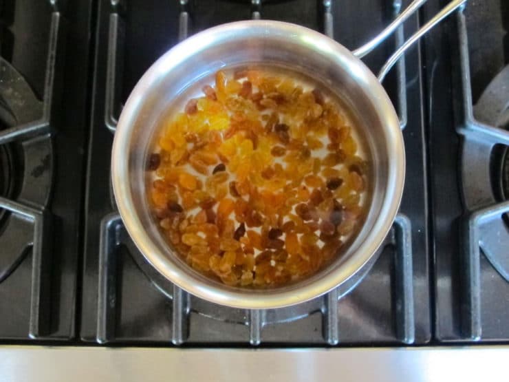 Soaking raisins in warm water to soften.