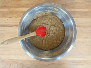 Folding muffin batter together until just mixed.