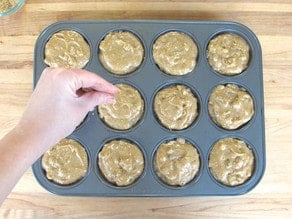 Topping muffin tin with sugar.