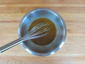 Eggs and sugar whisked in a bowl.