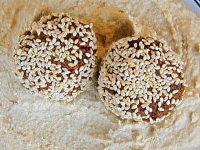 Sesame falafel balls on hummus.