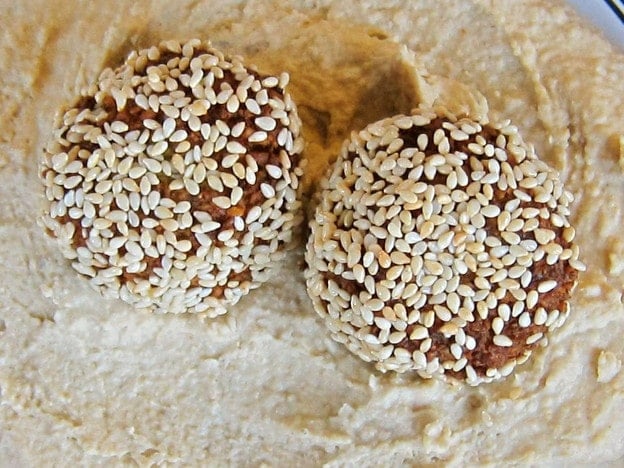 Sesame falafel balls on hummus.