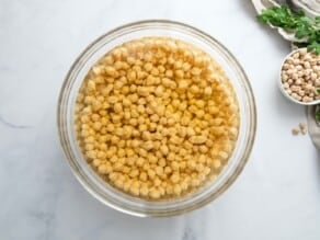 Horizontal image of glass bowl filled with chickpeas (garbanzo beans).