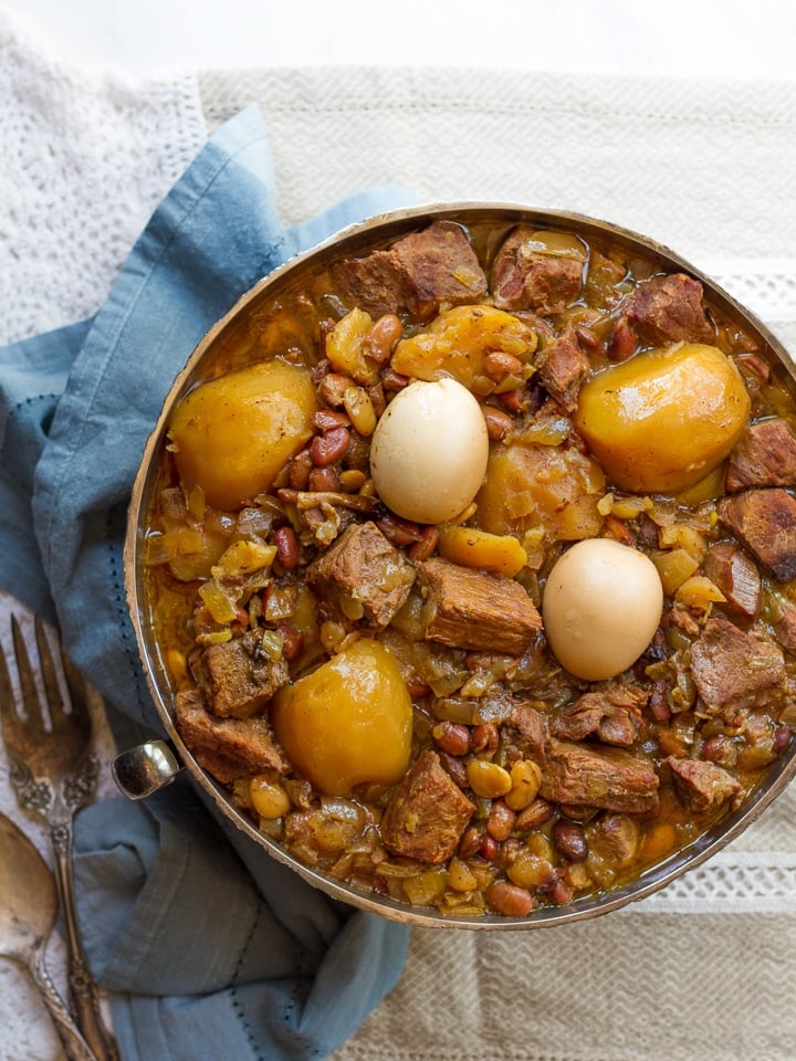 Hot plate for the Sabbath, a pot of spicy meat cooked with potatoes,  barleys, wheat and eggs. Pot of cholent Hamin in hebrew, challah-special  bread in Jewish cuisine. Traditional food Jewish Shabbat