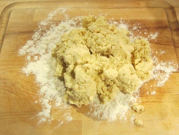 Rugelach dough on a cutting board.