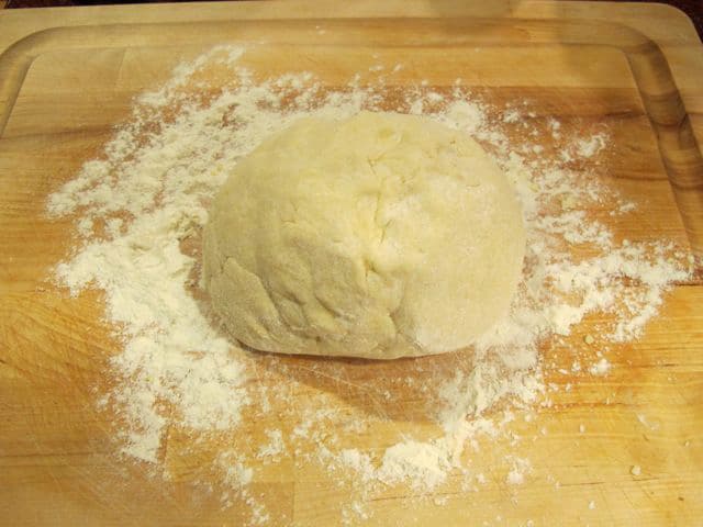 Rugelach dough on a cutting board.