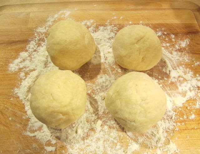Rugelach dough split into four sections.