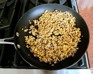 Dry toasting chopped nuts in a skillet.