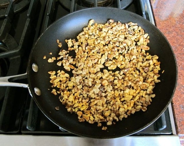 Dry toasting chopped nuts in a skillet.