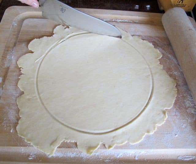 Cutting out dough circle.