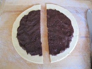 Cut rugelach circle dough in half.