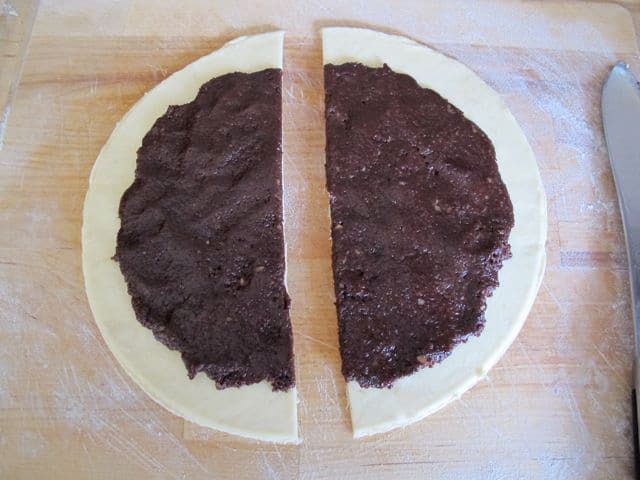 Cut rugelach circle dough in half.
