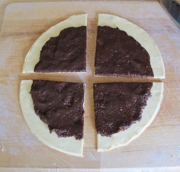 Cut dough circle in quarters.