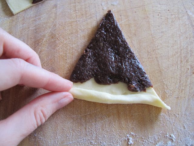 Rolling rugelach from wide end.