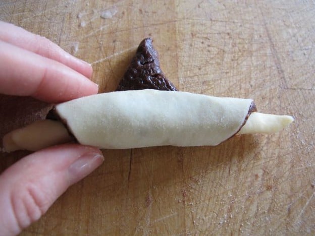 Rolling rugelach from wide end.