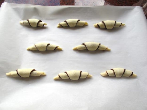 Rugelach on a lined baking sheet.