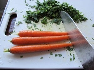 Chopping carrots on a cutting board.
