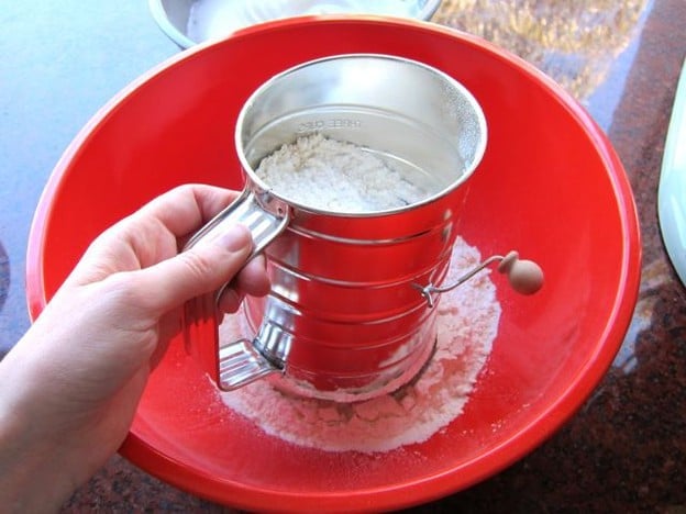 Sifting dry cake ingredients.