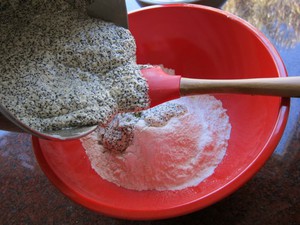 Adding butter to dry cake ingredients.