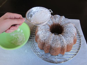 Dusting bundt cake with powdered sugar.