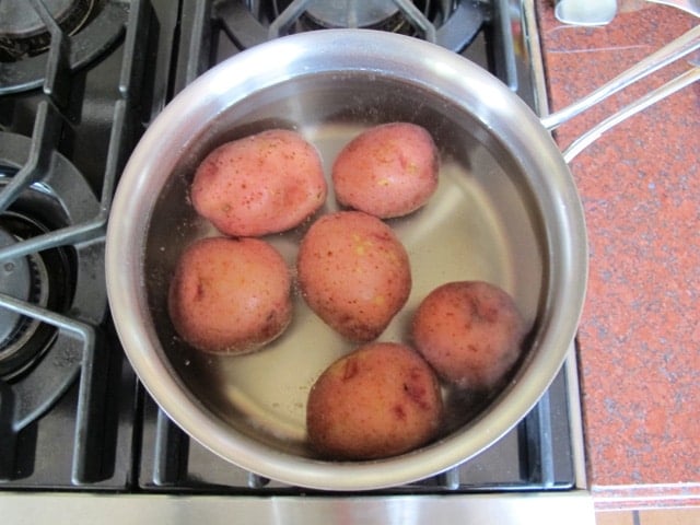 Red potatoes in boiling water.