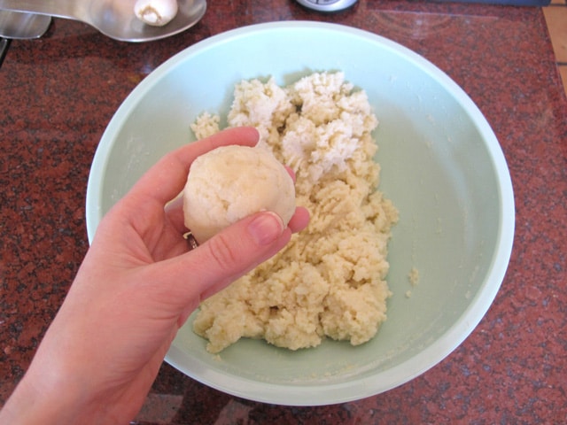 Forming potato dough into balls.