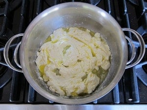 Melting butter and cream cheese in a saucepan.