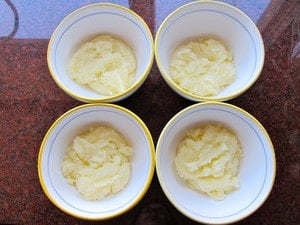 Dough divided into four small bowls for coloring.