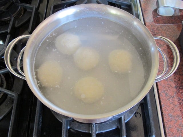 Cooking potato balls in hot water.