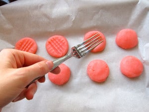 Using a fork to press designs in candies.