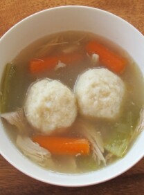 Top view of a Chicken Soup bowl with Matzah Balls, turnip, and carrots