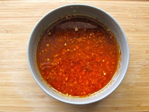 Olive oil and seasonings in a small bowl.