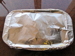 Roasting pan covered with foil.