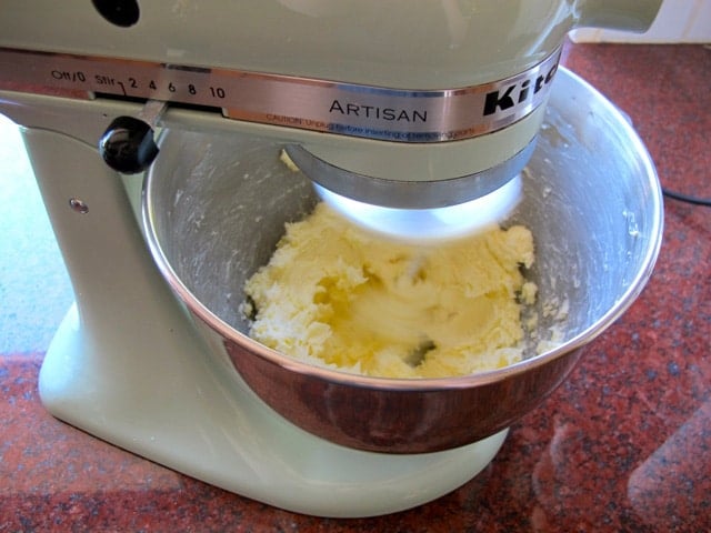 Beating butter in a stand mixer.