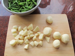 Peeled potatoes cut into large chunks.