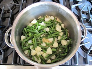 Pasta, green beans, and potatoes in a stock pot.