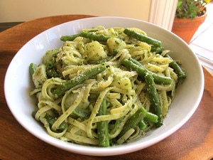 Cooked pasta and vegetables tossed in pesto.