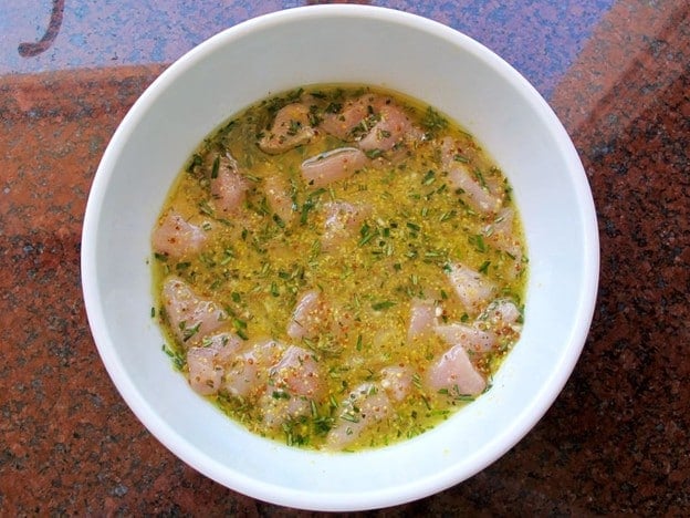 Cubed chicken in lemon marinade.
