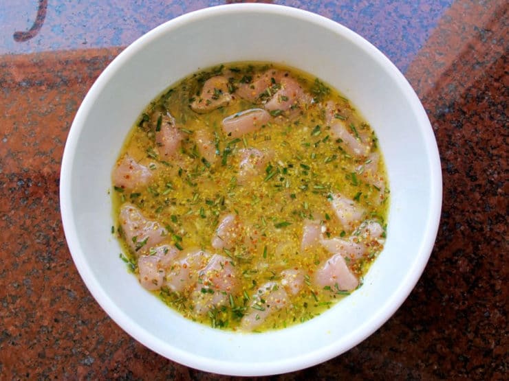 Cubed chicken in lemon marinade.