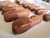 Dipped cookies drying on parchment.