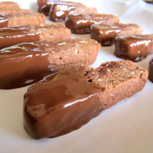 Dipped cookies drying on parchment.