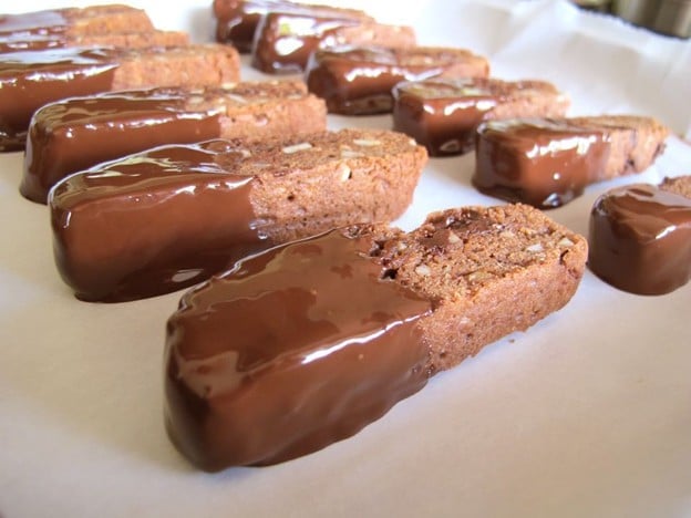 Dipped cookies drying on parchment.
