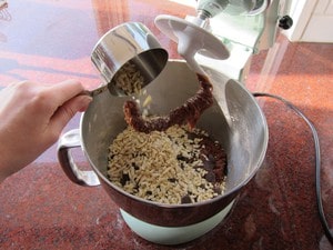 Folding mixins into dough in stand mixer.