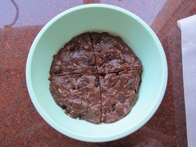 Cookie dough in a bowl cut into four sections.