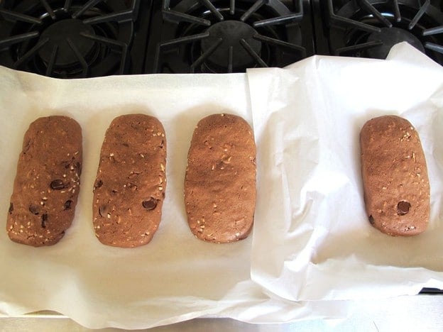 Baked cookie logs on a sheet.