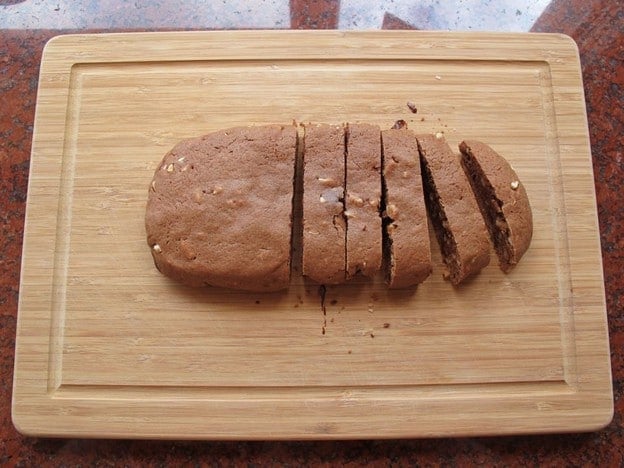 Slicing parbaked cookie dough into strips.