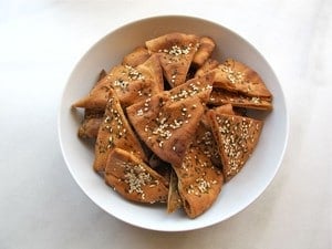 Baked pita chips in a bowl.